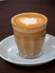 Closeup of a Glass of Coffee Latte on a wooden table in a Sydney Cafe