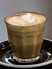Closeup of a Glass of Coffee Latte on a wooden table in a Sydney Cafe