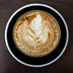 Closeup of a Glass of Coffee Latte on a wooden table in a Sydney Cafe