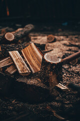 lumberjack cutting wood at sunset with axe splinters 