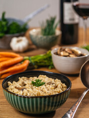 Bowl of Risotto on a table with ingredients