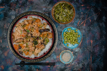 Vegan chirashizushi  made with yuba, shiitake, broccoli and pepper in traditional bowl along with wakame, edamame.