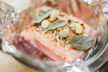 raw pork with garlic and Bay leaf on foil