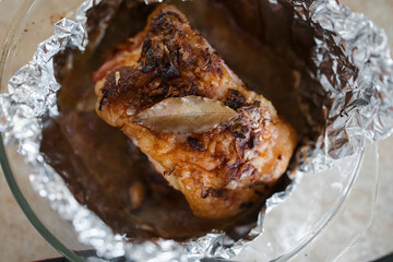 baked pork with a crust with garlic and Bay leaf on foil