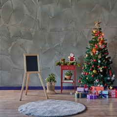 Christmas, New Year interior with grey stone wall background, wooden black board, gift and fir tree.