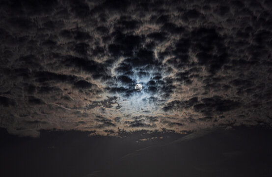 Close up picture of the shiny full moon with cirrostratus clouds