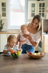 mom with two children in the kitchen