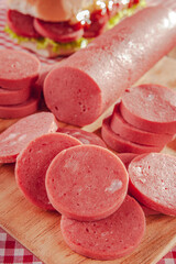 Slices of big sausage on cutting board