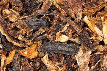 Heap of dried edible mushrooms on the market. Different dried mushrooms.
