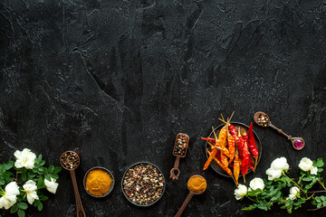 Hot spices and aromatic herbswith cooking utensils overhead