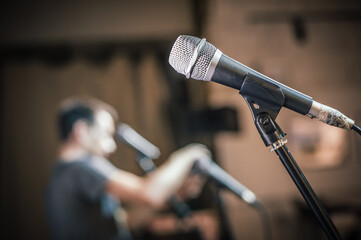 Theater audio technician adjusting an microphones on the scene. Installing and testing the sound...