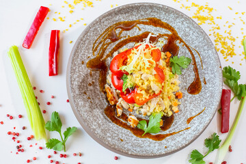 Chicken breast with bulgur baked in pepper in a gray ceramic plate in a restaurant. Top view. Selective focus. Super short focus