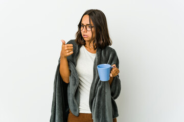 Young latin woman with blanket isolated on white background