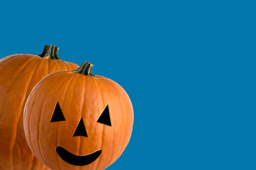 Halloween jack O 'Lantern, orange pumpkin in abstract graphics on blue background ,text space
