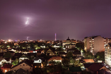 Obraz premium Evening city by storm with thunder and lightning