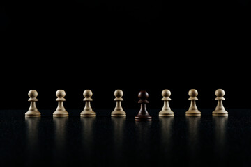row of chess pieces on black background