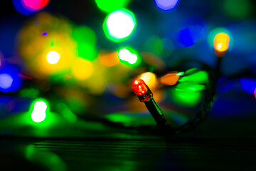 Fototapeta na wymiar Christmas lights close up photo. Cozy mood in the evening. Festive time. Holidays concept.