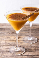 Pumpkin cocktail in glass Pumpkin cocktail in glass on wooden table