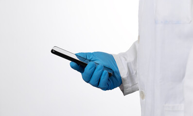 The doctor holds a cell phone in hand for online patient consultation.