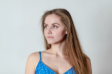 Fototapeta premium Caucasian women wearing a blue dress with. She is looking over her right shoulder