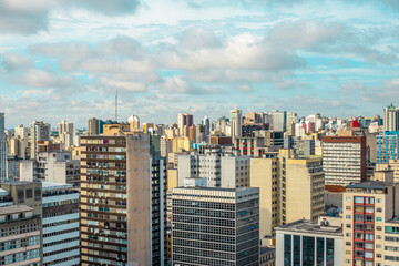 Fototapeta na wymiar Aerial view landscape of urbanized center with colorful buildings and blue sky with white clouds - Curitiba, capital of Paraná state, Brazil