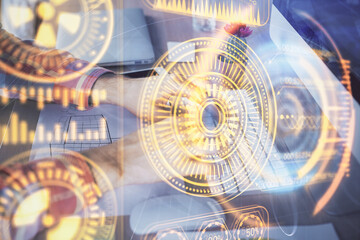 Technology theme hologram with man working on computer on background. High tech concept. Double exposure.