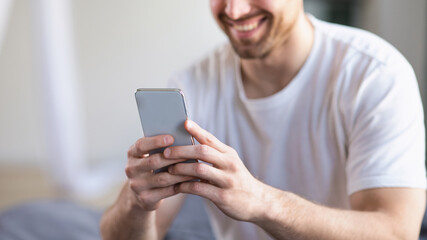 Unrecognizable Man Using Smartphone Mobile App Sitting In Bedroom, Panorama