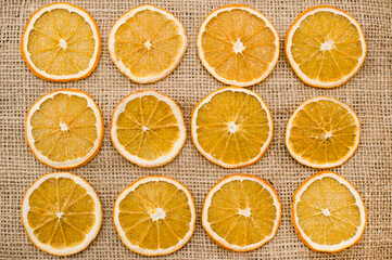 Dried Orange slices on linen cloth. Christmas decoration. Advent ornaments. Ethnographic ornamentation background