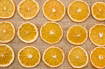 Dried Orange slices on linen cloth. Christmas decoration. Advent ornaments. Ethnographic ornamentation background