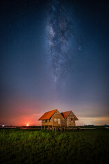 Landscape image of milky way over the abandoned twin house near Chalerm Phra Kiat road in Thale...
