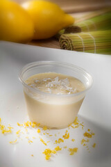 Sicilian Lemon Mousse with Lemon Slices and Fruit in the Background