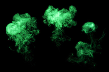 Set of abstract isolated moving smoke on black background. Green luminous isolated chaotic puffs of...