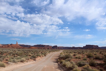 Scenic drive with a gorgeous southwest desert landscape featuring canyons and sandstone buttes in Valley of the Gods, Utah
