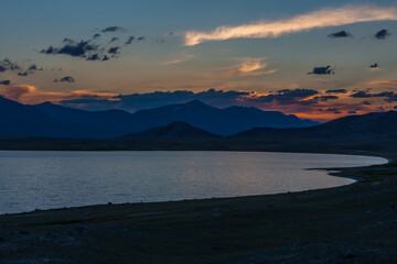 Mountain landscape at sunset. Outstanding view of the mountain ridges and clouds. Mountain Lake in Altai of Mongolia