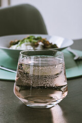 Glass of juice water with bubbles 