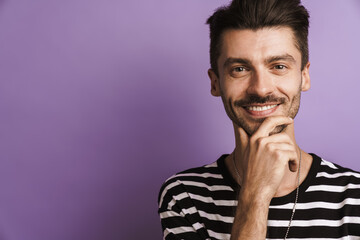 Photo of joyful handsome man smiling and looking at camera