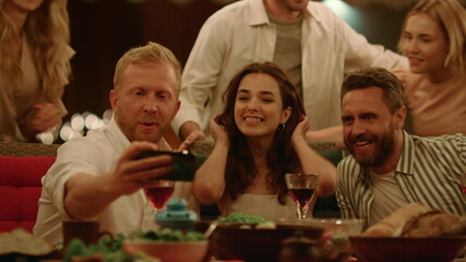 Friends making selfie photo on smartphone. Young people having fun together