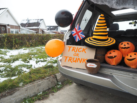 Trick or trunk. Concept celebrating Halloween in trunk of car. New trend celebrating traditional October holiday outdoor. Social distance and safe alternative celebration during coronavirus covid-19 © arsenypopel