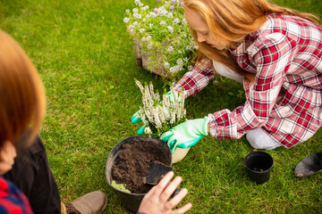 Farmers. Happy brother and sister planting in a garden outdoors together. Love, family, lifestyle, harvest, autumn concept. Cheerful, healthy and lovely. Organic food, agriculture, gardening.