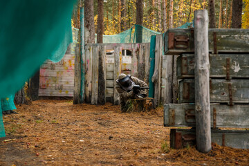 a man in the woods playing paintball