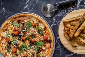 delicious homemade pizza with sauce, cheese ready to eat on white marble