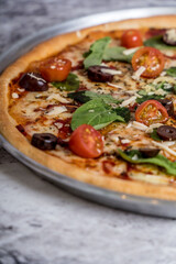 delicious homemade pizza with sauce, cheese ready to eat on white marble