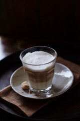 Glass of Latte Macchiato. Rustic background. Close up.	