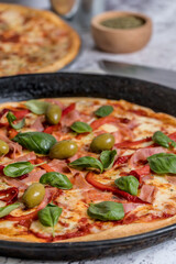delicious homemade pizza with sauce, cheese ready to eat on white marble