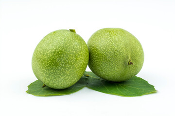 Two walnuts in peel isolated on white background.