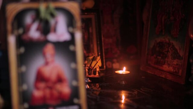 Traditional Indian oil lamp illuminating Hindu Gods. Static, shallow focus