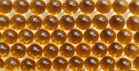 Background from yellow capsules. Fish oil capsules