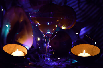 night beach party with orange cocktail glass and candles