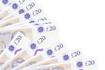 20 British pounds bills lies isolated on white background with copy space stacked in fan close up