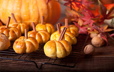 Pumpkin buns on the baking rack. Autumn concept.